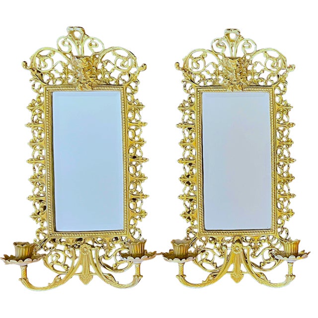 Exceptional pair of ornate lacquered brass wall mirrors with integrated twin candelabra arms by celebrated American maker...