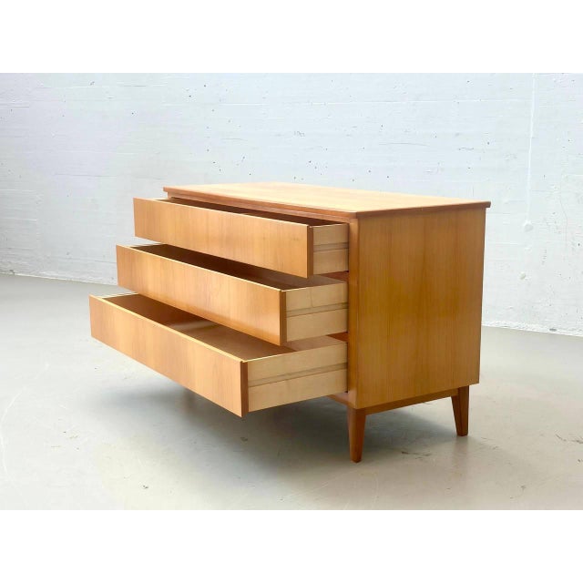 Elegant vintage mid-century chest of drawers with three spacious drawers. The design is characterized by its clean,...