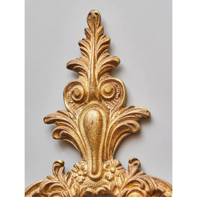 Detailed wall lamp in the rococo style. The lamp is cast from bronze and gilded. Very high-quality workmanship. The lamp...