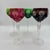 A set that feels collected rather than matched—four cut-to-clear crystal hock glasses in rich jewel tones, each catching...