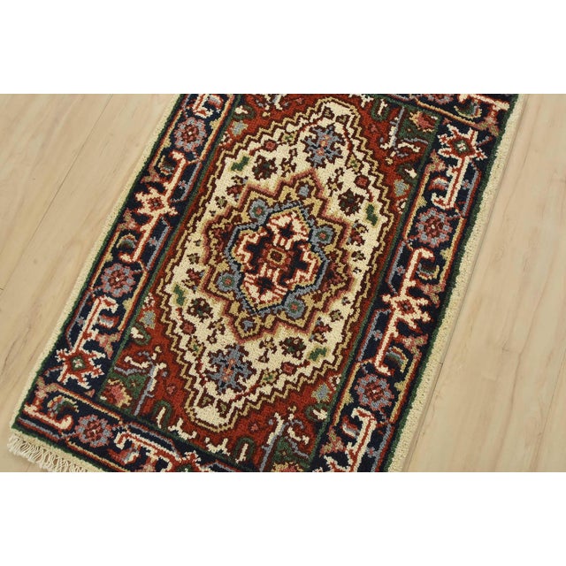 A traditional tribal Heriz rug hand-knotted with fine wool on a cotton foundation. This oriental rug features a central...