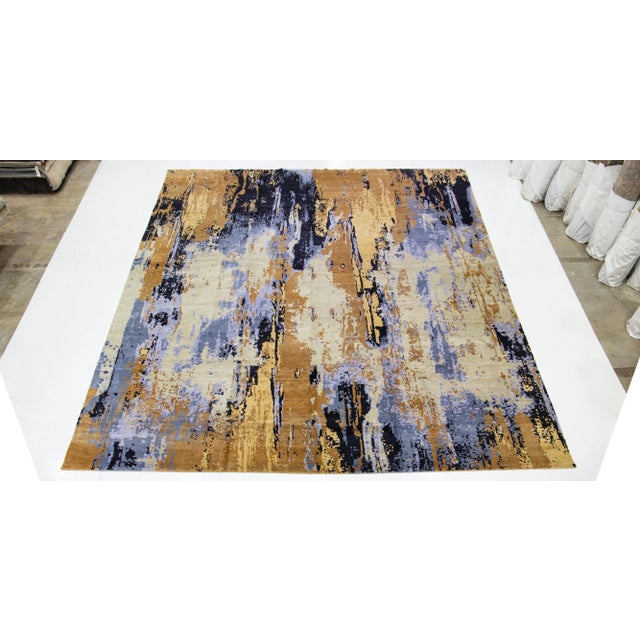 A beautiful large modern hand-knotted wool rug with an ivory field, black, blue and yellow accents in all over abstract...