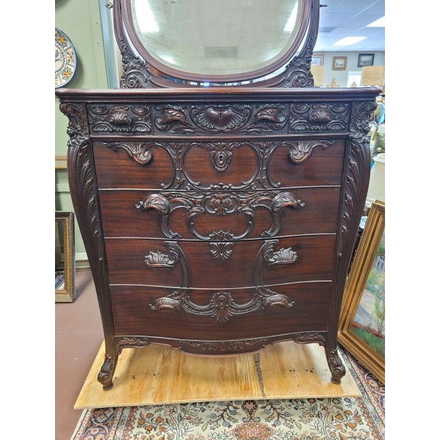 A magnificent French highly carved dresser attributed to R. J. Horner Furniture of New York. Features vanity style beveled...