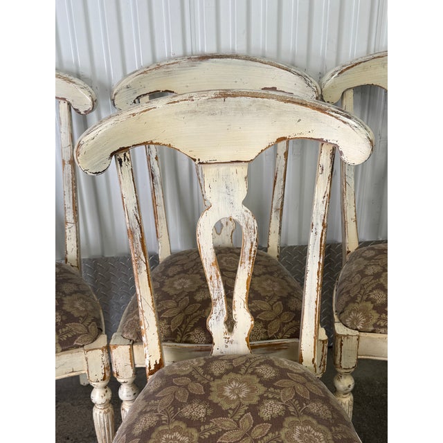 Gorgeous set of 4 chairs by Buying and design. The chair has a curved top rail, a pierced splat, and turned legs. Heavily...