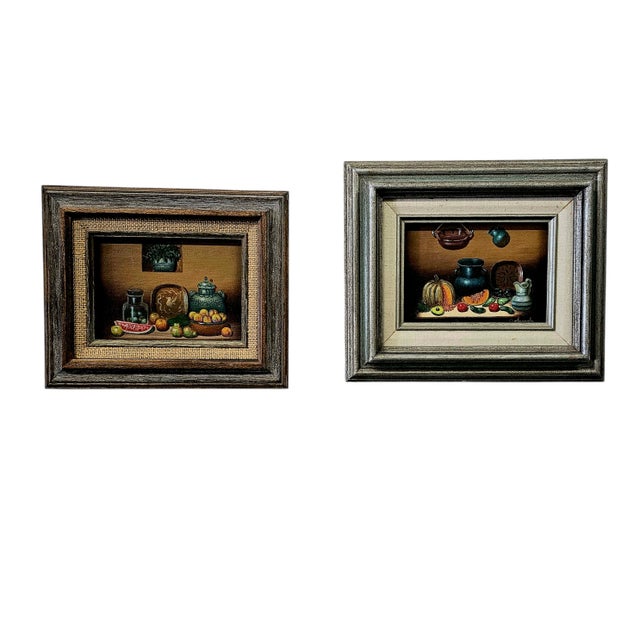 Original matching pair of vintage still-life paintings by Orlando, c. 1990s.Oil on board with detailed kitchen / pottery...