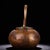 This is a finely crafted antique copper teapot, hand-hammered and featuring ornate gemstone inlays. The body is of squat,...