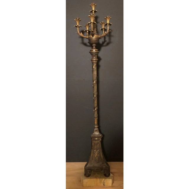A refined pair of Louis XVI–style torchères, electrified for modern use and executed in bronze and composition, mounted on...