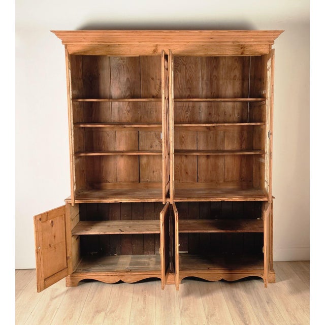 A handsome antique English pine breakfront bookcase. Formerly built into a wall, now a freestanding cabinet. 19th century...