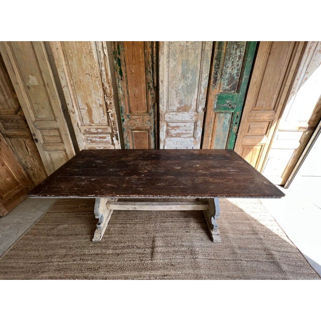 19th C Italian trestle table, with a natural wood top, and a painted split pedestal base. This table was sourced from the...