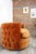 Large swivel armchair upholstered in ultra-soft orange velvet