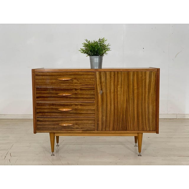 A beautiful chest of drawers • German design • 60s original • good condition • walnut • key available Dimensions: Height:...