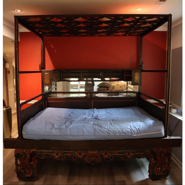Gorgeous Chinese wedding bedframe featuring intricate decorative carvings, a mirrored sideboard, cabinets and shelving for...