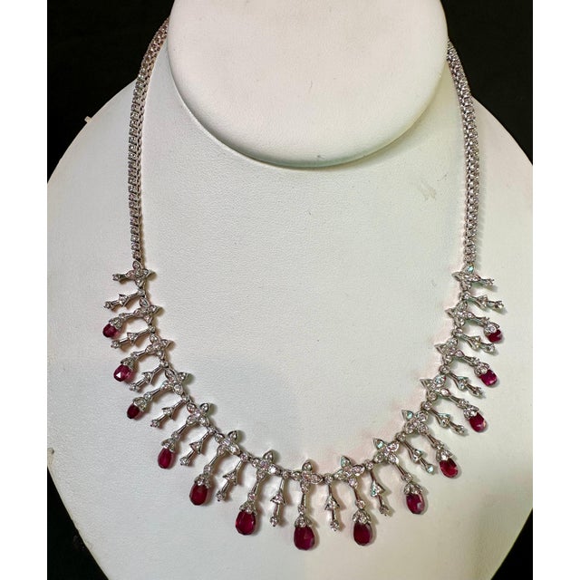 This exquisite Estate Necklace showcases a collection of 13 Natural Ruby Briolettes, totaling approximately 18 carats. The...