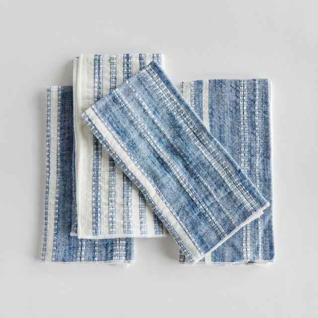 Bring a touch of softness to the table with this set of four cotton napkins. Beautiful in tone and texture, the rich blue...