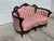 An absolutely charming antique Victorian loveseat featuring a beautifully hand-carved solid walnut frame paired with its...
