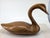 An iconic, carved-wooden decoy swan, standing at a commanding 27 inches as the main attraction, is a wondrous sculptural...