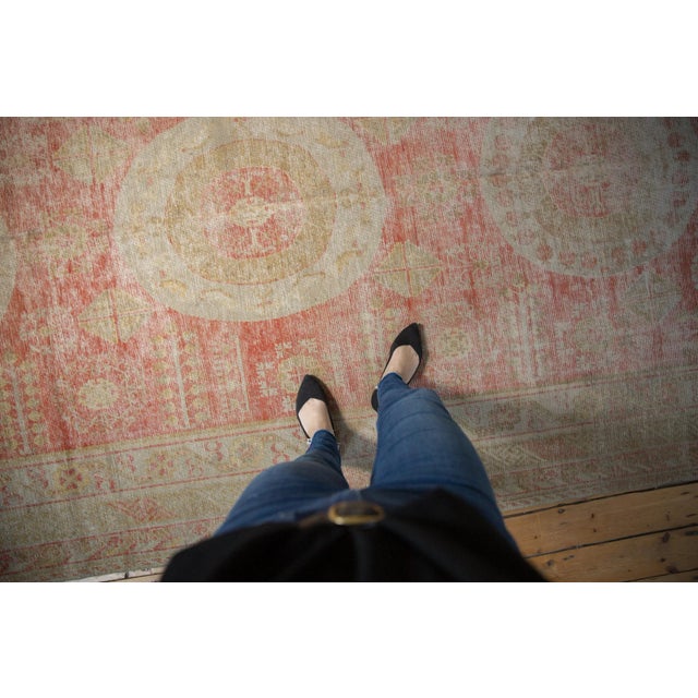 :: Distressed antique Khotan carpet circa 1910. Triple medallion atop a covered field of red. Wonderful neutral and soft...