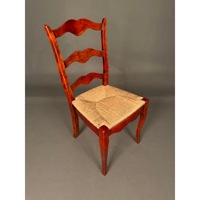 Beautiful pair of Country French style side chairs featuring elegant cabriole legs, ladder-back splats, and hand-woven...