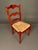 Beautiful pair of Country French style side chairs featuring elegant cabriole legs, ladder-back splats, and hand-woven...