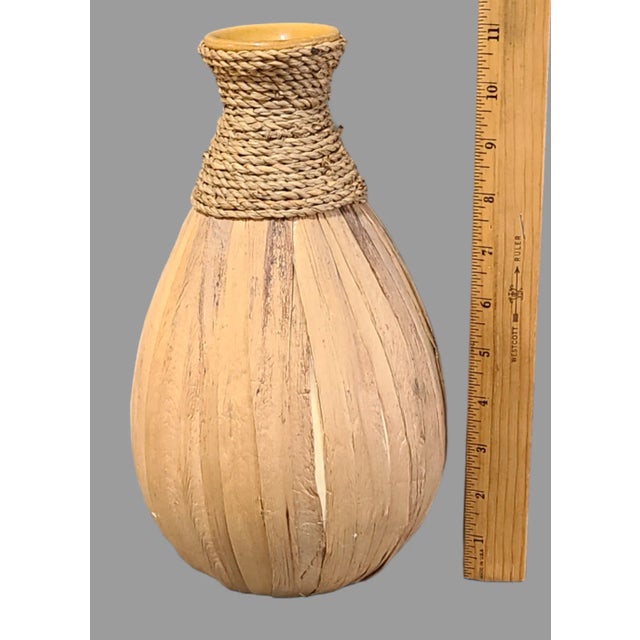 This beautiful pottery decanter is a tribute to nature, wrapped in seagrass and bamboo leaves. The glazed finish adds a...