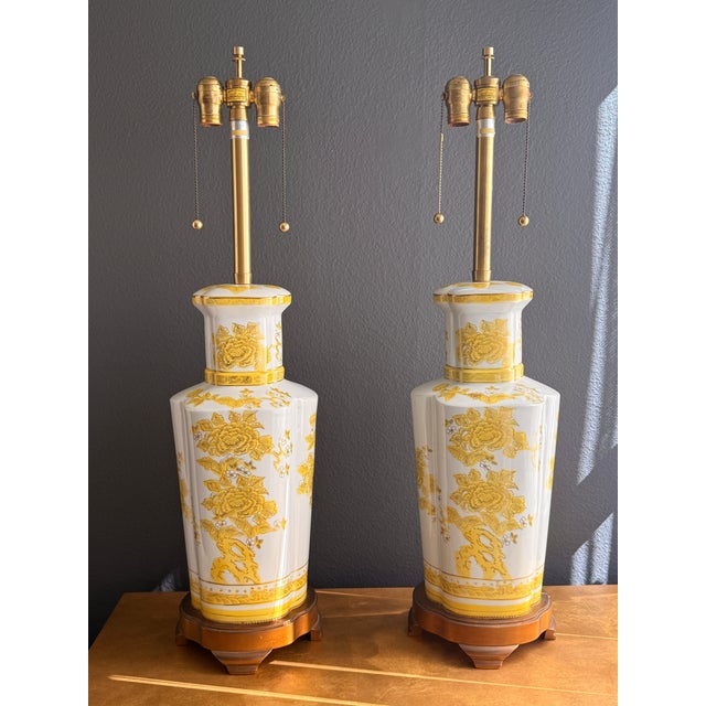 Pair of Japanese porcelain chinoiserie lamps by Marbro Lighting Co. decorated with yellow foliage and flowers.