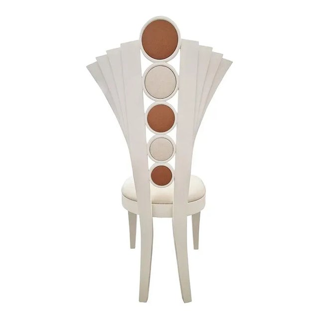 Ivory -colored chair with padded faux leather seat and fan -shaped back with round details in padded eco -leather...