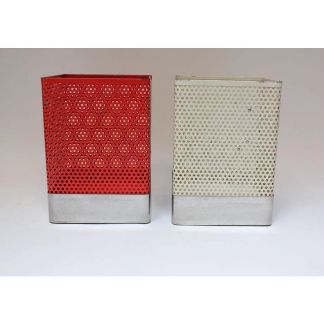 Mathieu Matégot-Style wastebaskets/trashcans composed of perforated metal vessels (one red, one cream) with aluminum trim...