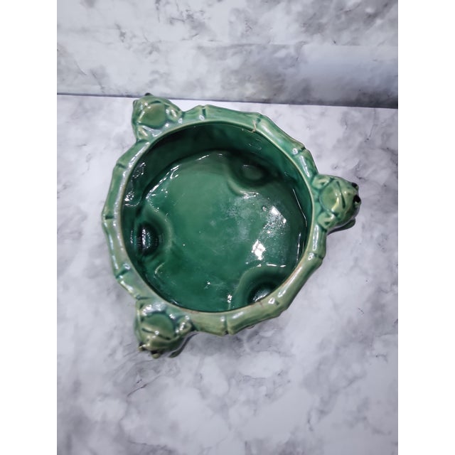 Rare footed majolica frog on a lily pad planter. Three sweet frogs climbing up the rim of this incredible planter.