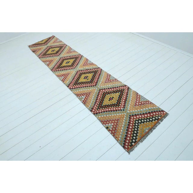 This beautiful, traditional vintage, flatweaved Turkish runner is approximately 60 years old. It is handmade of very fine...