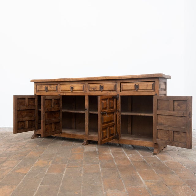 An imposing antique Spanish sideboard in solid pine, remarkable for its highly architectural facade and substantial...