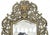 Antique Rococo Revival beveled wall mirror in cast brass. The swirling foliate designs are center pieced by Bacchus,...