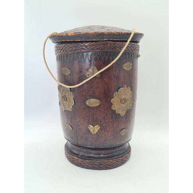 A traditional Indian wooden “mana” measuring cup, historically used to measure rice, grains, and other loose products. The...