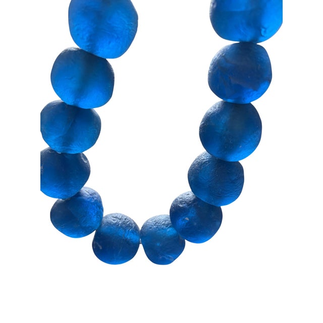 One strand of authentic African handmade glass trade beads strung on hemp. These substantial jumbo beads each measure...
