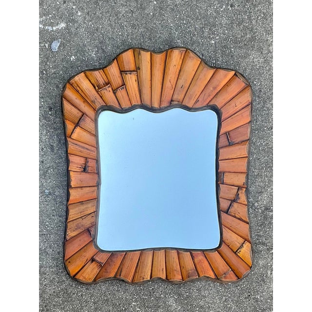 Add a touch of tropical warmth and organic texture to your walls with this charming vintage split bamboo mirror. Crafted...