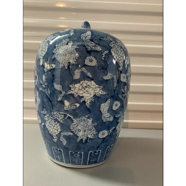 This elegant ceramic ginger jar features a classic blue and white design, adorned with a charming butterfly and floral...
