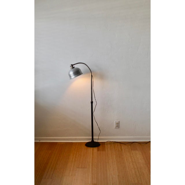 Vintage M. Brandt & Sons style industrial floor lamp featuring an adjustable gooseneck arm, a cast-iron base, and a dome-...