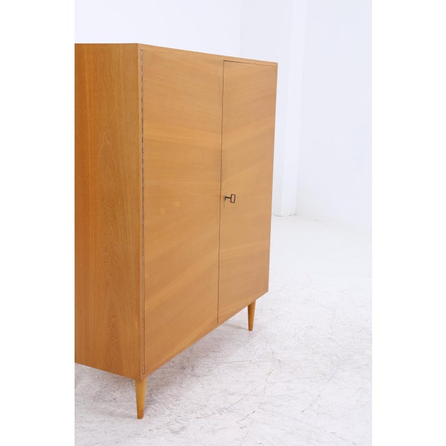 A stylish mid-century cabinet from the 1960s with a beautiful wood finish and functional layout. Versatile and perfect for...