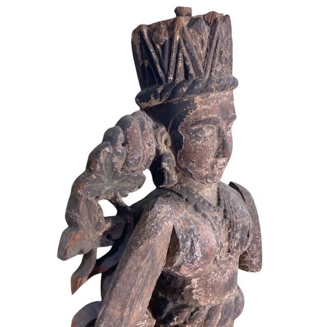 This antique Indonesian crowned angel, carved by hand from wood in the early 19th century, is a museum quality piece....