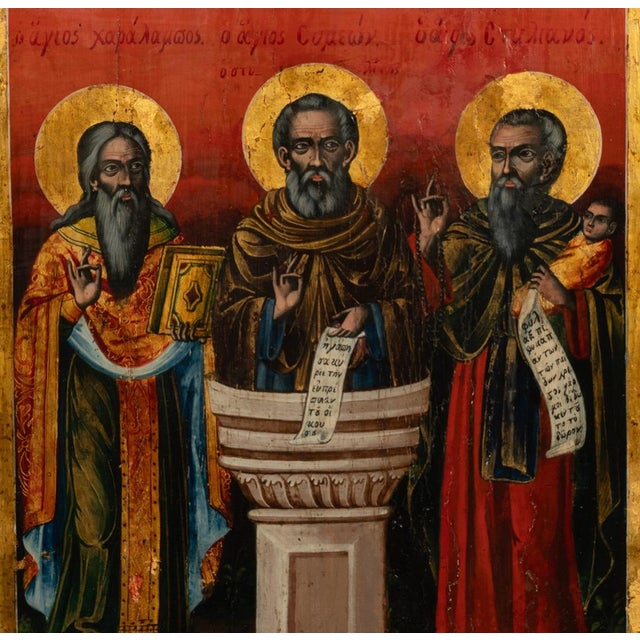 A good and large, late 18th century, Greek, Eastern Orthodox hand-painted & gilded icon of three saints, circa 1780. This...
