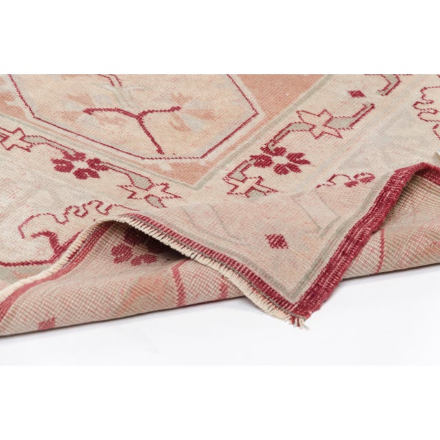 This is a vintage Turkish Oushak rug from the 1960s. The piece was hand-knotted.