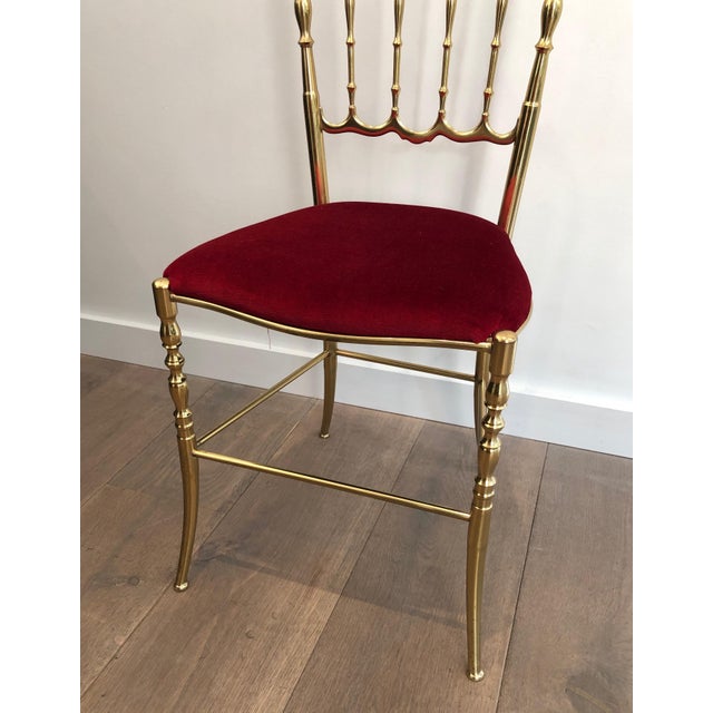 This rare set of a brass Chiavari chair and its stool or ottoman with seats covered in red velvet. This is an Italian...