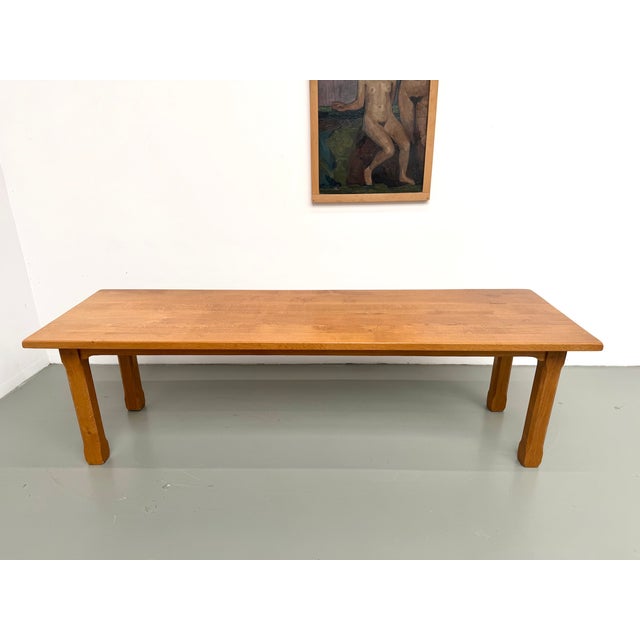 This large, brutalist-style dining table from the 1970s, crafted entirely from solid oak, is distinguished by its clean,...