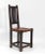 Arts & Crafts movement oak & leather arrowhead side chair with single linen fold central carved splat. Circa 1905....