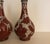 A pair of Chinese Cloisonne vases in cinnabar and white color. The gord form with slim taper neck and bulbous body. The...