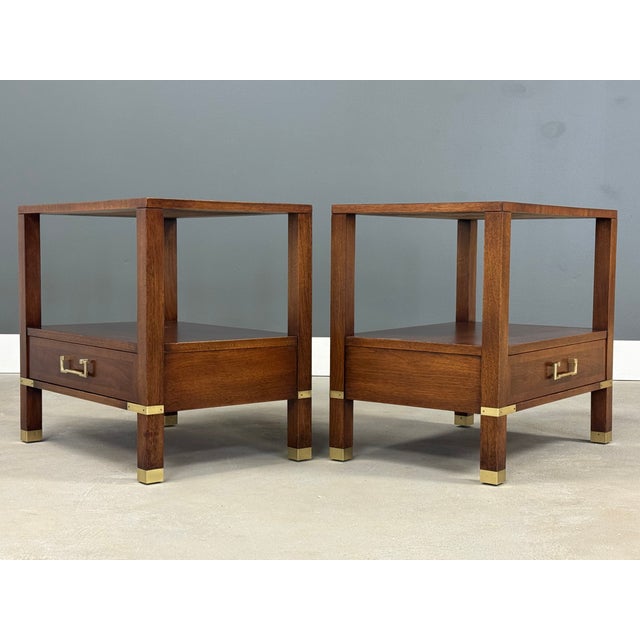 A pair of mid century modern walnut single drawer nightstands by Sligh Furniture a Baker company. Polished brass accents...