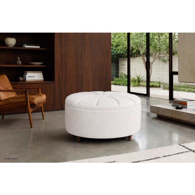 Mid-century modern round ottoman manufactured in the United States, circa 1960s. This sculptural piece captures the...