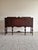 This sideboard credenza is crafted with book-matched, herringbone-veneered door panels and a solid carved apron and base....