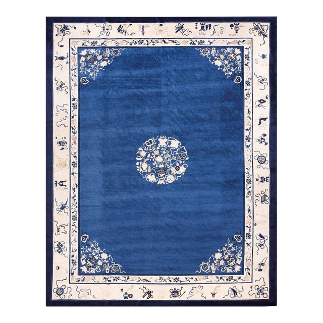 Fascinating Royal Blue Open Field With Floral Border in a Qing Style Antique Chinese Peking Rug For Sale