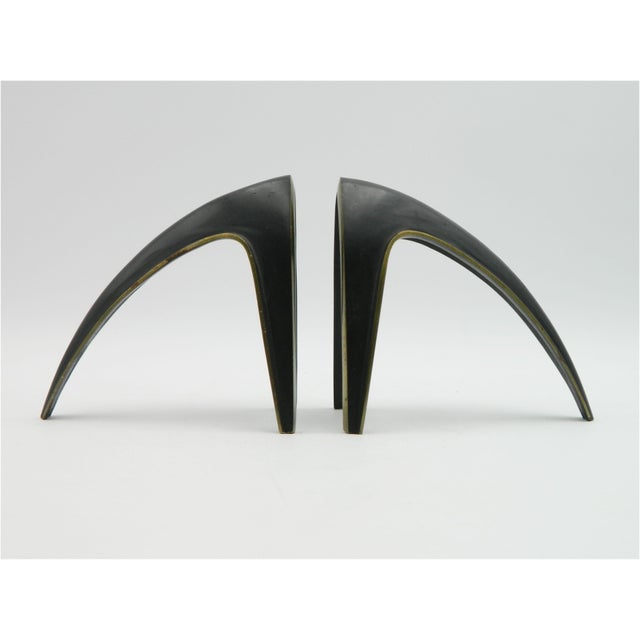 An exceptional pair of bookends from the Richard Rohac workshop in Vienna. Made of cast brass, patinated and polished....