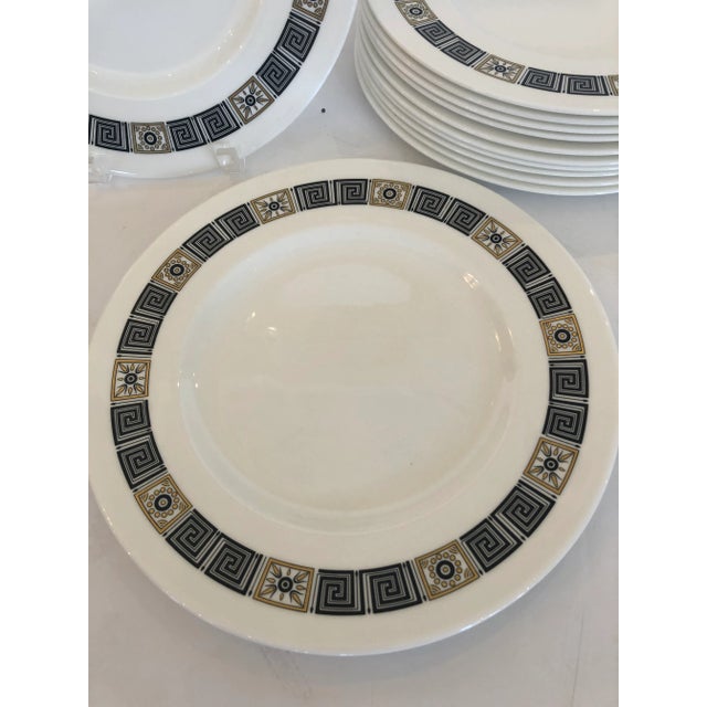 A delicious set of 12 Wedgwood dinner service plates having black and gold border with fabulous Greek key motife.